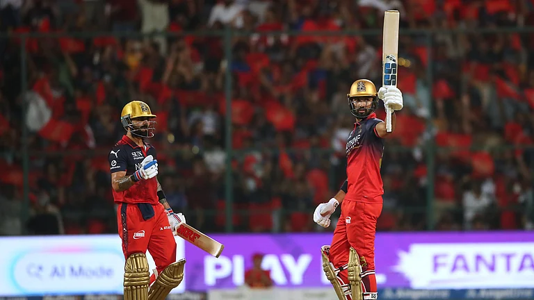 Royal Challengers Bengaluru's Devdutt Padikkal celebrates his fifty runs as batting partner Virat Kohli looks during the Indian Premier League cricket match between Royal Challengers Bengaluru and Gujarat Titans in Bengaluru, India, Friday, April 24, 2026. - (AP Photo)