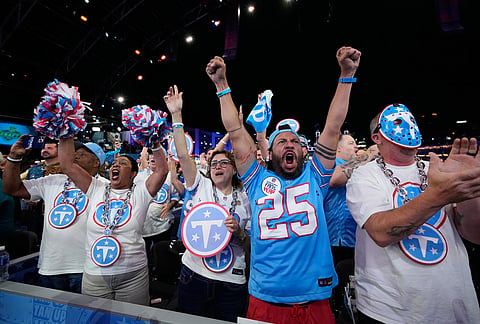 Tennessee Titans fans celebrate after a pick during the first round of the NFL football draft, in Pittsburgh. 