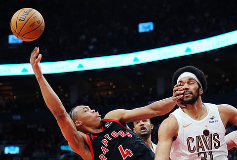 Toronto Raptors' Scottie Barnes (4) tries to shoot over Cleveland Cavaliers' Jarrett Allen (31) during the second half of an NBA playoff basketball game in Toronto.