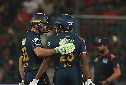 
Gujarat Titans' Jos Buttler congratulates batting partner Sai Sudharsan on scoring a century on during the Indian Premier League cricket match between Royal Challengers Bengaluru and Gujarat Titans in Bengaluru.
