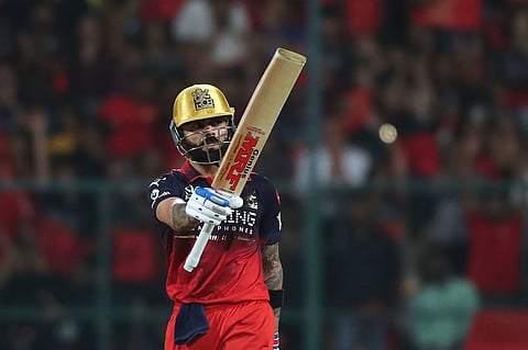 Royal Challengers Bengaluru's Virat Kohli celebrates his fifty runs during the Indian Premier League cricket match between Royal Challengers Bengaluru and Gujarat Titans in Bengaluru.