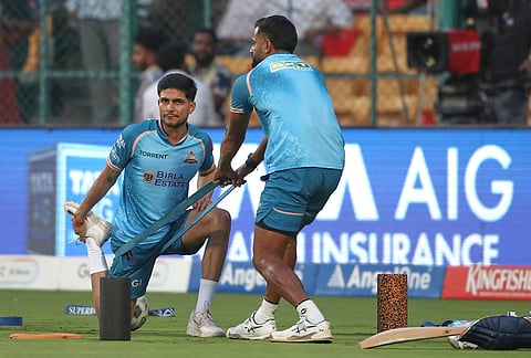 Gujarat Titans' captain Shubman Gill warms up at the start of the the Indian Premier League cricket match between Royal Challengers Bengaluru and Gujarat Titans in Bengaluru.