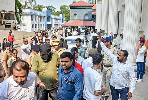 Police escort accused to a court in connection with a case related to the TCS unit, where they were taken into custody in another case and produced before the court, in Nashik.