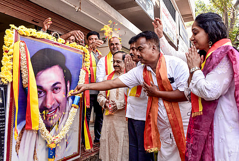 Fans pay floral tribute to the portrait of Kannada Film actor Dr Rajkumar on the latter’s 97th birth anniversary, in Chikkamagaluru, Karnataka.