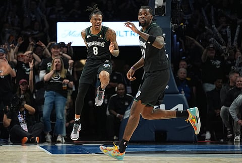 Minnesota Timberwolves guard Bones Hyland (8) celebrates next to center Naz Reid (11) after making a 3-point shot during the second half in Game 3 of a first-round NBA basketball playoff series against the Denver Nuggets, in Minneapolis.
