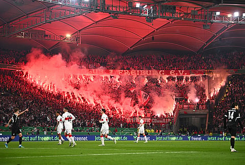 Freiburg fans set off pyrotechnics during a German Cup semifinal soccer match between VfB Stuttgart and SC Freiburg, in Stuttgart, Germany.  

