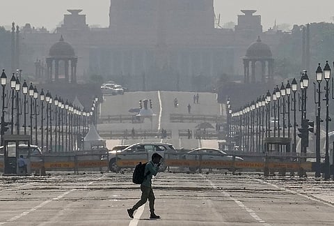 A man walks at Kartavya Path amid heat on a summer afternoon, in New Delhi.