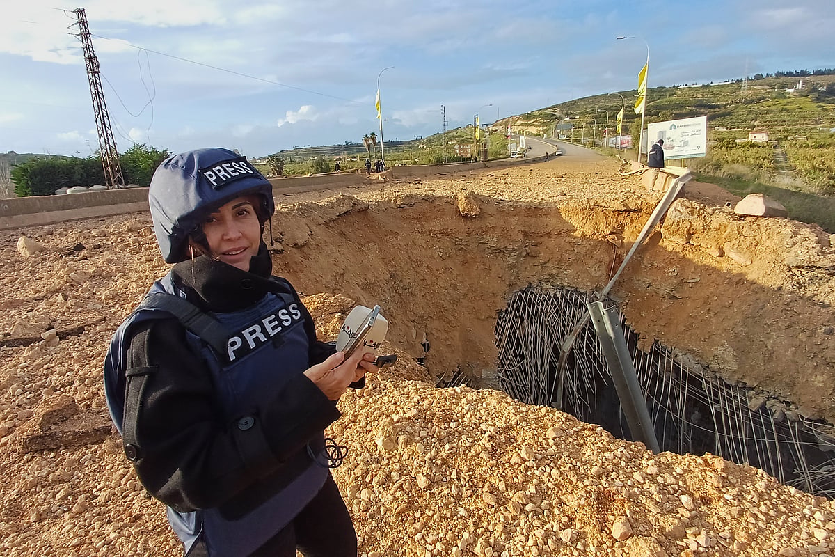 Lebanese journalist Amal Khalil, who worked for the daily Al-Akhbar newspaper, while reporting near a destroyed bridge in Qasmiyeh, Lebanon, Sunday, March 22, 2026.  - (AP Photo/Mohammed Zaatari)