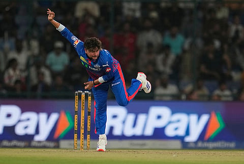 Delhi Capitals' Kuldeep Yadav bowls a delivery during the Indian Premier League cricket match between Delhi Capitals and Punjab Kings in New Delhi.