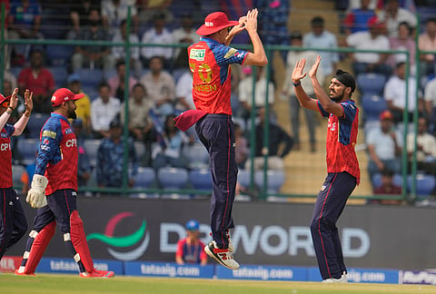 Punjab Kings' Arshdeep Singh, right, celebrates with teammates the wicket of Delhi Capitals' Pathum Nissanka during the Indian Premier League cricket match between Delhi Capitals and Punjab Kings in New Delhi.