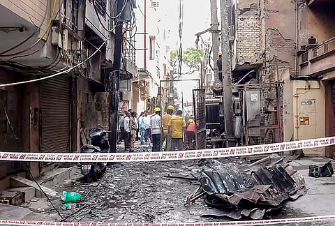 Officials present at the site after a major fire broke out in an electric transformer and spread to multiple residential buildings at Laxmi Nagar area, in New Delhi. At least 14 people were rescued in this incident. 