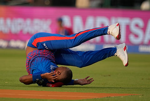 Delhi Capitals' Lungi Ngidi loses his balance while attempting to take a catch during the Indian Premier League cricket match between Delhi Capitals and Punjab Kings in New Delhi.