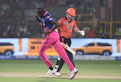Sunrisers Hyderabad's Travis Head leaves the ground after losing his wicket as Rajasthan Royals's Jofra Archer celebrates during the Indian Premier League cricket match between Rajasthan Royals and Sunrisers Hyderabad in Jaipur.