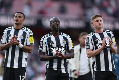 Newcastle players applaud to supporters at the end the English Premier League soccer match between Arsenal and Newcastle United in London.