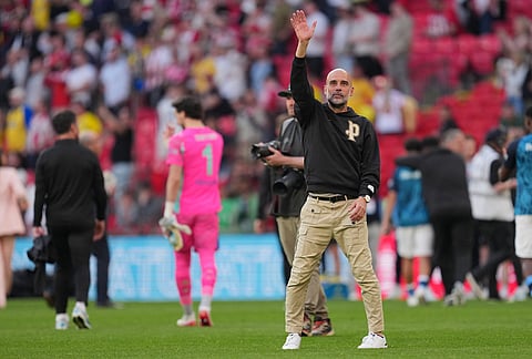 Manchester City's head coach Pep Guardiola reacts after the FA Cup semifinal soccer match between Manchester City and Southampton in Manchester, England.