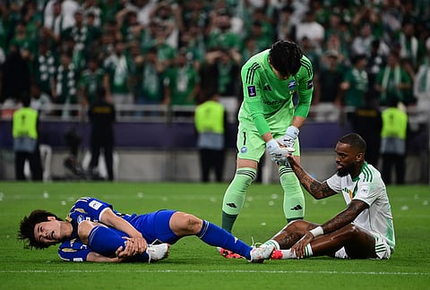 Machida Zelvia goalkeeper Kosei Tani helps Al-Ahli's Ivan Toney during their AFC Champions League Elite Final soccer match at King Abdullah Sports City Stadium, in Jeddah, Saudi Arabia.