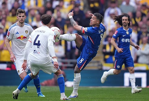 Chelsea's Enzo Fernandez reaches for the ball in front of Leeds' Ethan Ampadu during the FA Cup semifinal soccer match between Chelsea and Leeds in London, England.