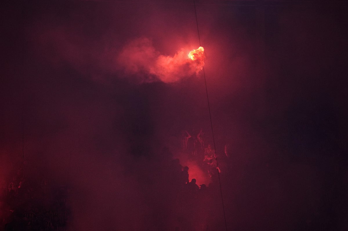 Galatasaray's supporters light flares as they celebrate a goal during a Turkish Super Lig soccer match between Galatasaray and Fenerbahce in Istanbul, Turkey.