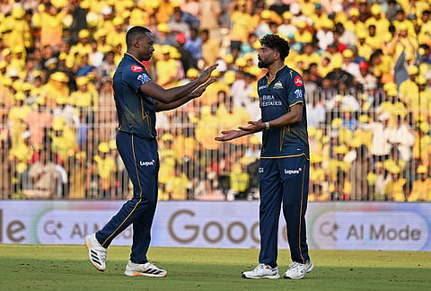 Gujarat Titans' Kagiso Rabada, left, and teammate Mohammed Siraj celebrate the wicket of Chennai Super Kings' Kartik Sharma during the Indian Premier League cricket match between Chennai Super Kings and Gujarat Titans in Chennai.