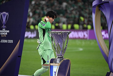 Machida Zelvia goalkeeper Kosei Tani walks past the trophy after his team lost to Al-Ahli in the AFC Champions League Elite soccer match in Jeddah, Saudi Arabia.
