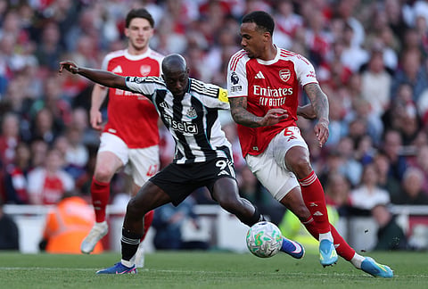 Arsenal's Gabriel, right, and Newcastle's Yoane Wissa challenge for the ball during the English Premier League soccer match between Arsenal and Newcastle United in London.