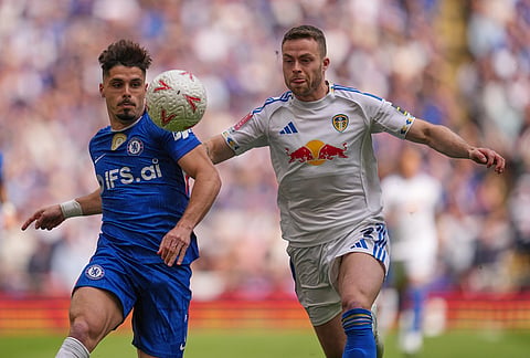 Chelsea's Pedro Neto, left,a nd Leeds' Gabriel Gudmundsson fight for the ball during the FA Cup semifinal soccer match between Chelsea and Leeds in London, England.