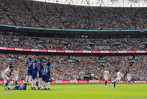 Leeds' Ao Tanaka takes a free kick during the FA Cup semifinal soccer match between Chelsea and Leeds in London, England.