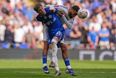 Chelsea's Alejandro Garnacho, left, and Leeds' Joel Piroe fight for the ball during the FA Cup semifinal soccer match between Chelsea and Leeds in London, England.