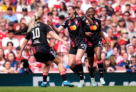 OL Lyonnes' Jule Brand, center, celebrates after scoring the opening goal during the Women's Champions League semi-final, first leg soccer match between Arsenal and OL Lyonnes in London, England.