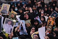 | Photo: AP/Hassan Ammar : A woman mourns as other hold portraits of Hezbollah fighters, who were killed before the ceasefire in the war between Hezbollah and Israel, during a mass funeral procession in the southern village of Kfar Sir, Lebanon, Tuesday, April 21, 2026. 