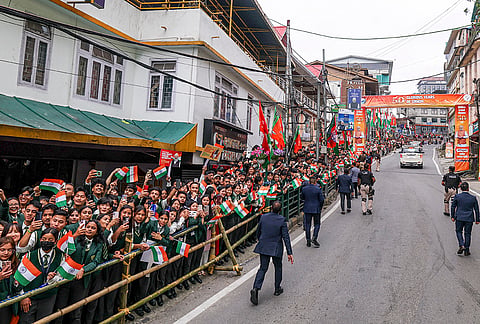 People gather during Prime Minister Narendra Modi's, unseen, roadshow, in Gangtok, Sikkim. 