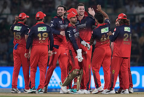 Royal Challengers Bengaluru's Josh Hazlewood, center, celebrate with teammates the wicket of Delhi Capitals' KL Rahul during the Indian Premier League cricket match between Delhi Capitals and Royal Challengers Bengaluru in Delhi.