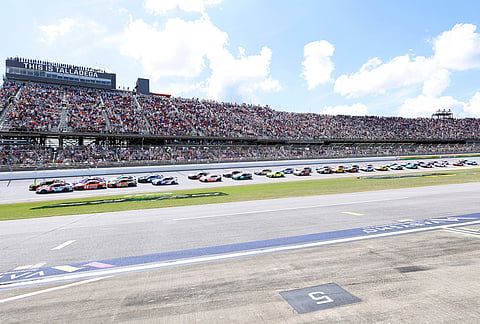 Tyler Reddick (45) and Kyle Larson (5) lead the pack to the start during a NASCAR Cup Series auto race in Talladega, Alabama.
