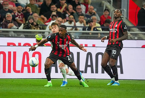 AC Milan's Pervis Estupinan, front, fights for the ball during the Serie A soccer match between AC Milan and Juventus, in Milan, Italy.