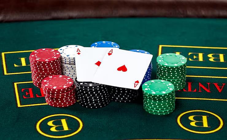 Two Aces next to stacks of colorful casino chips - null