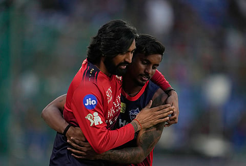 Royal Challengers Bengaluru's Krunal Pandya, left, and Delhi Capitals' Abishek Porel before the start of the Indian Premier League cricket match between Delhi Capitals and Royal Challengers Bengaluru in Delhi.
