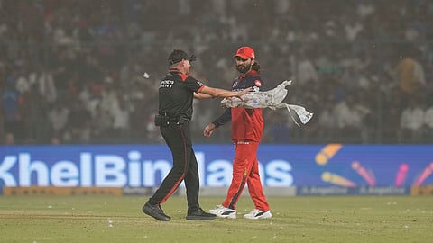 Rajat Patidar reacts amid a dust storm during the Indian Premier League match between Delhi Capitals and Royal Challengers Bengaluru, in New Delhi.