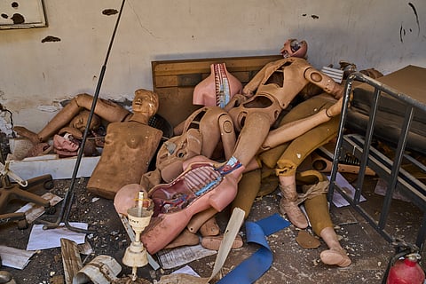 Medicine mannequins are piled on the floor at a war-damaged section of Al Shaabi Hospital in Khartoum