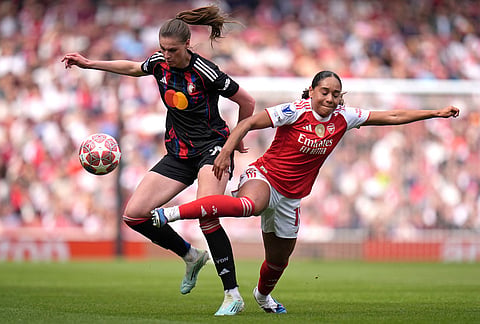Arsenal's Olivia Smith, right, and OL Lyonnes' Jule Brand, left, challenge for the ball during the Women's Champions League semi-final, first leg soccer match between Arsenal and OL Lyonnes in London, England.