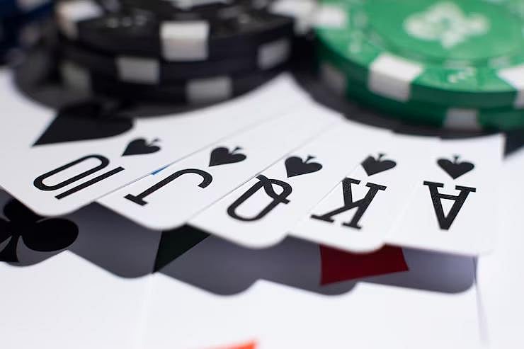 Royal Flush in Spades with poker chips - null
