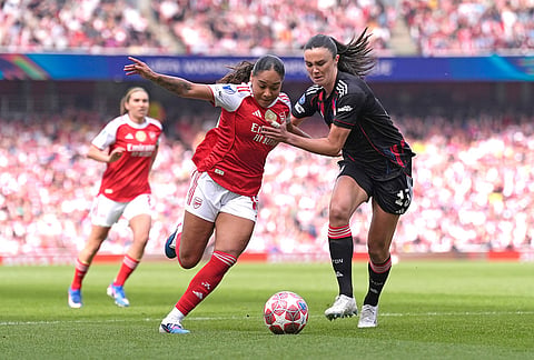Arsenal's Olivia Smith, left, and OL Lyonnes' Ingrid Engen, right, challenge for the ball during the Women's Champions League semi-final, first leg soccer match between Arsenal and OL Lyonnes in London, England.