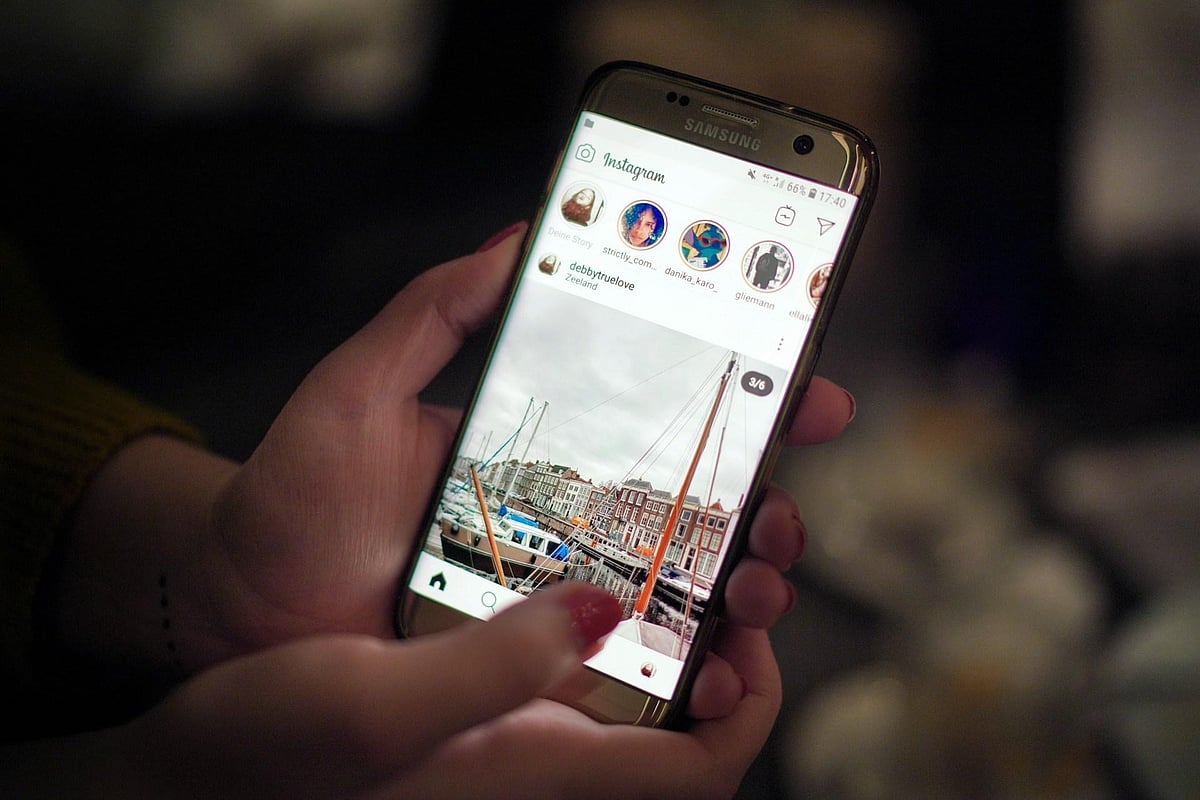 A person holding phone showing Instagram