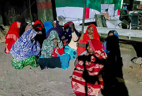 Women from families displaced by the Ken-Betwa Link Project sit in protest on the ground outside the SDM office late at night, in Chhatarpur, Madhya Pradesh.