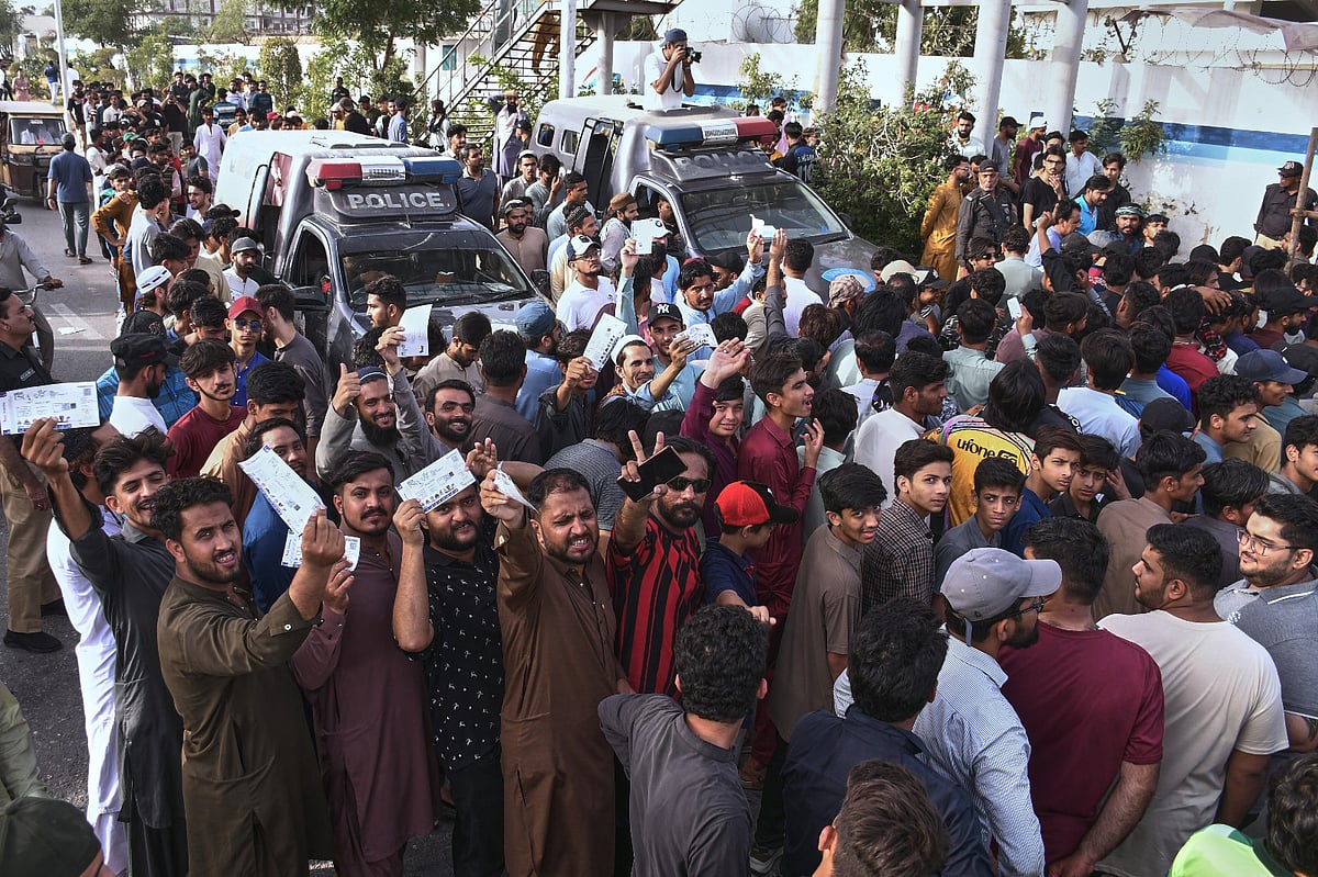 Fans stand in queues and wait for the opening of the National Stadium for the Pakistan Super League Qualifier cricket match between Peshawar Zalmi and Islamabad United, in Karachi, Pakistan, Tuesday, April 28, 2026.