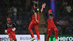 (AP Photo/Manish Swarup) : Royal Challengers Bengaluru's Josh Hazlewood, center, and Virat Kohli, right, celebrates the wicket of Delhi Capitals' Sameer Rizvi during the Indian Premier League cricket match between Delhi Capitals and Royal Challengers Bengaluru in Delhi, India, Monday, April 27, 2026.