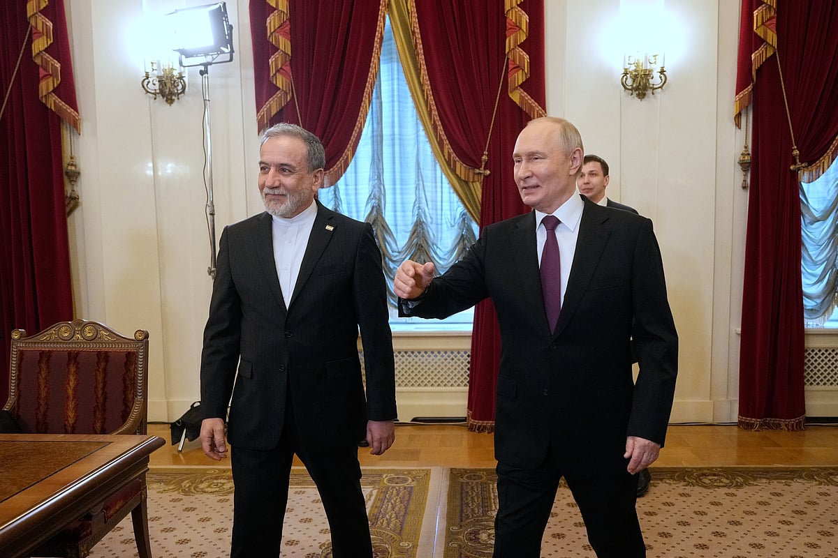 Russian President Vladimir Putin, right, and Iranian Foreign Minister Abbas Araghchi walk to attend the talks at the Boris Yeltsin Presidential Library, in St. Petersburg, Russia.
 - AP Photo/Dmitri Lovetsky 