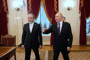 AP Photo/Dmitri Lovetsky : Russian President Vladimir Putin, right, and Iranian Foreign Minister Abbas Araghchi walk to attend the talks at the Boris Yeltsin Presidential Library, in St. Petersburg, Russia.