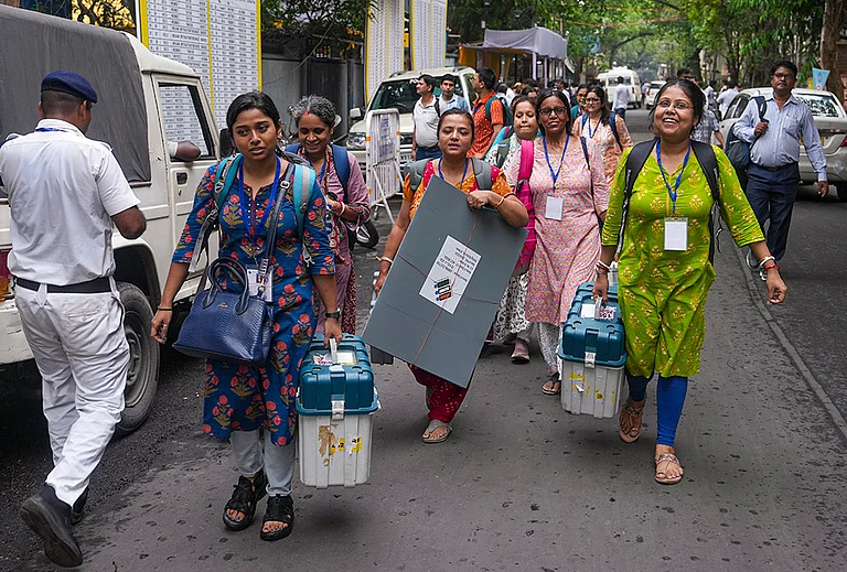 Officials leave for their respective polling stations after collecting Electronic Voting Machine (EVM) and Voter Verifiable Paper Audit Trail (VVPAT) units for voting in the second phase of the West Bengal Assembly elections, in Kolkata. - | Photo: PTI/Manvender Vashist Lav