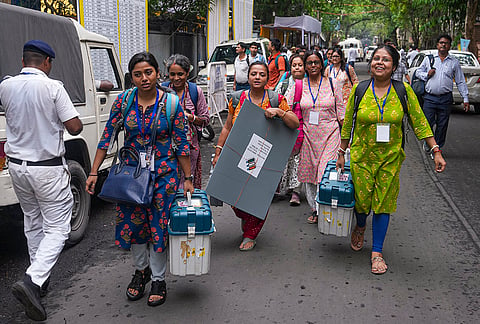 Officials leave for their respective polling stations after collecting Electronic Voting Machine (EVM) and Voter Verifiable Paper Audit Trail (VVPAT) units for voting in the second phase of the West Bengal Assembly elections, in Kolkata.