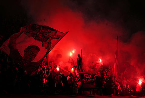 PSG fans light flares on the stands during a Champions League semifinal, first leg, soccer match between Paris Saint-Germain and Bayern Munich in Paris.